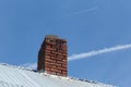 Jet contrails, old roof and chimney Royalty Free Stock Photo