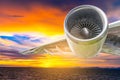 Jet engine against the sunset over the sea Royalty Free Stock Photo