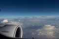 Jet engine aircraft. Blue sky in the horizon and white clouds below. Royalty Free Stock Photo