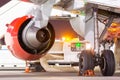 Jet engine and main landing gear, rear view on the night apron of the airport Royalty Free Stock Photo