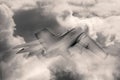 Jet fighter flying in sky with fluffy clouds