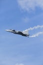 Jet fighter flying with white smoke