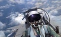 Jet fighter pilot flying over cloudy sky