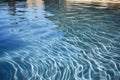 jet-injected water stream creating ripples in a calm pool