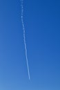 A jet leaving vapour trail in clear blue sky Royalty Free Stock Photo