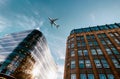 Jet plane aircraft traveling in the sky over the center of Glasgow city buildings. Royalty Free Stock Photo