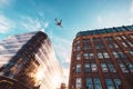 Jet plane aircraft traveling in the sky over the center of Glasgow city buildings. Royalty Free Stock Photo