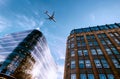 Jet plane aircraft traveling in the sky over the center of Glasgow city buildings. Royalty Free Stock Photo