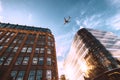 Jet plane aircraft traveling in the sky over the center of Glasgow city buildings. Royalty Free Stock Photo