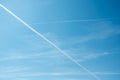 Jet plane contrails. Aircraft routes on blue sky. White airways traces. Long lasting condensation trails, chemtrails Royalty Free Stock Photo