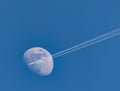 Jet plane on blue sky against moon Royalty Free Stock Photo