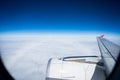 Jet plane flying over white cloud and clear blue sky above Royalty Free Stock Photo