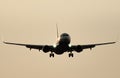 Jet plane landing against clear sky at dusk Royalty Free Stock Photo