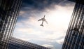 Jet plane plying in business district area, office buildings Royalty Free Stock Photo