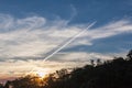 Jet plane trail, sunset landscape