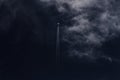 Jet plane and vapor trails going straight up across a deep blue sky and dense white cloud. Royalty Free Stock Photo