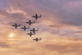 Jet planes flying in formation again a warm colored cloudscape