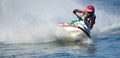 Jet Ski cornering at speed creating at lot of spray. Royalty Free Stock Photo