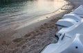 Jet ski lining up. The water sports vehicle park above the sand. Tides getting low. Pebbles and crushed corals scattering around. Royalty Free Stock Photo