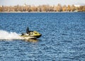A jet ski with a man racing along the wide Dnieper River in Dnepropetrovsk