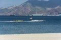 A jet ski pulls a banana boat filled with adventurous tourists. At Barretto Beach, a popular tourist spot near Subic in Olongapo, Royalty Free Stock Photo