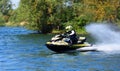 Jet Ski  race competitor moving  at speed creating at lot of spray. Royalty Free Stock Photo