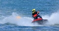 Jet Ski  racer creating at lot of spray black and red jet-ski Royalty Free Stock Photo