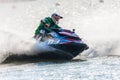 Jet ski racer drives watercraft splashing in sunset while racing at South Russian Aquabike Championship Royalty Free Stock Photo