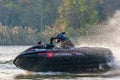 Jet ski racer drives watercraft splashing in sunset while racing at South Russian Aquabike Royalty Free Stock Photo