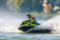 Jet ski racer drives watercraft splashing in sunset while racing at South Russian Aquabike Royalty Free Stock Photo