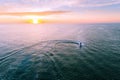 Jet ski rider doing donuts in water at sunset. Royalty Free Stock Photo