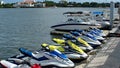 Jet skis moored along a floating pier