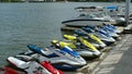 Jet skis moored along a floating pier