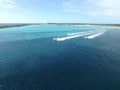 Jet skis traveling near an island in the Bahamas