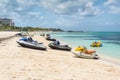 Jet skis water scooter, personal watercraft lie on the sand of the Goodman`s beach in Nassau, Bahamas