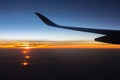 Jet in the sky at awesome sunrise. Plane wing above clouds. Beautiful view from airplane window. Morning colorful sky from plane. Royalty Free Stock Photo