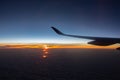 Jet in the sky at awesome sunrise. Plane wing above clouds. Beautiful view from airplane window. Morning colorful sky from plane. Royalty Free Stock Photo