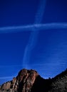 Jet trails form a cross at Zion National Park Royalty Free Stock Photo