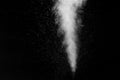 A jet of white water vapor with splashes of water from the humidifier Isolated on a black background. Royalty Free Stock Photo