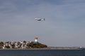 JetBlue airlines plane flying over a beach before landing in Boston