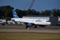 Jetblue white plane with colorful empennage taxiing to the runway at T.F. Green Airport Royalty Free Stock Photo