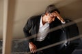 Jetlag...an exhausted young businessman sitting on the floor beside his luggage. Royalty Free Stock Photo