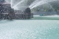 Drops and jets of water from a fountain in a water pool Royalty Free Stock Photo