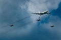 Jets flying in a formation near an airplane