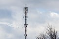 Jets flying in formation past a tall communications tower Royalty Free Stock Photo