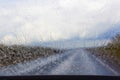 Jets of rain flowing down the windshield of a car.ÃÂ¡oncept of road hazard in bad weather, malfunctioning car wipers.Soft focus