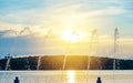 Jets of water fountain on the background sky and sun Royalty Free Stock Photo