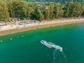 Jetski drives to the beach, aerial photo of Bang Thao beach in Phuket, Thailand