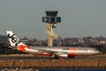 Jetstar Airways Airbus A330 aircraft taxis past the air traffic control tower at Sydney Airport