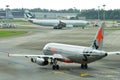 Jetstar Asia Airbus 320 preparing for departure as Cathay Pacific Airbus 330 taxi past